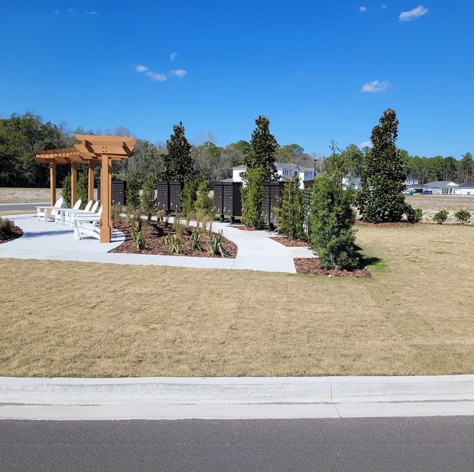 Another view of the landscaped outdoor area and concrete paths