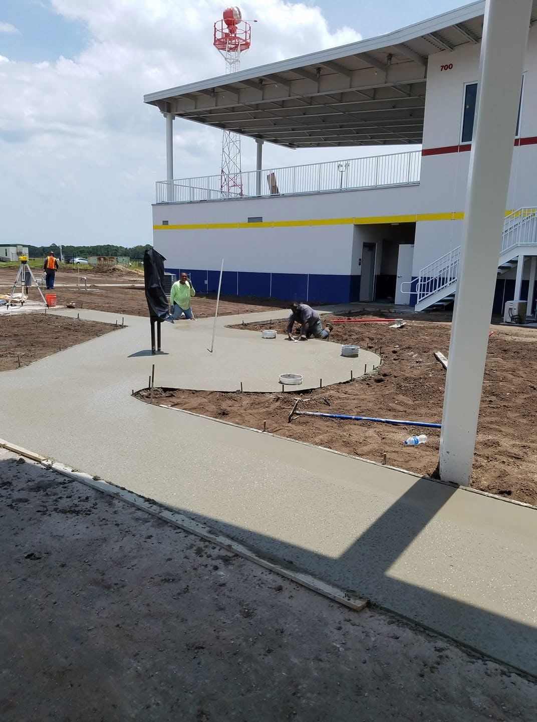 New concrete walkways surrounding a covered outdoor structure
