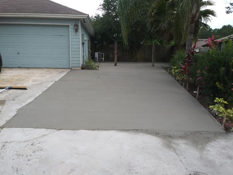 Fresh concrete driveway beside a residential garage